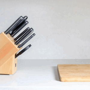 Modern kitchen cutlery set displayed on polished quartz surface